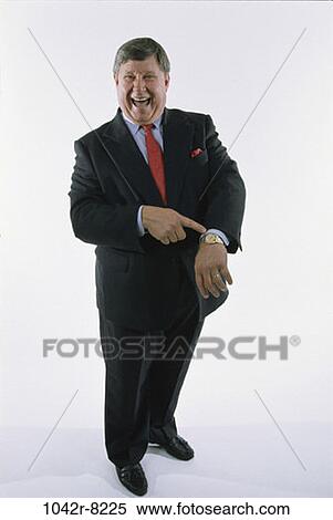 Stock Photography - watch, pointing, business, point, Middle-aged, humor. Fotosearch