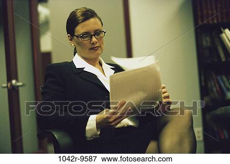 Stock Photo - woman, eyeglasses, business, Middle-aged, indoors, executive, Caucasian. Fotosearch