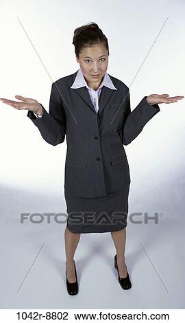 Stock Image - woman, Hispanic, business, frustrated, indoors, businesswoman, shrug. Fotosearch
