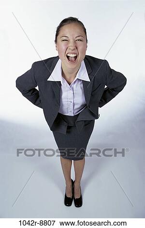 Stock Photo - woman, Hispanic, business, frustrated, angry, indoors, businesswoman. Fotosearch