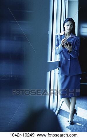 Stock Photo - woman, Hispanic, computer, business, indoors, travel, businesswoman. Fotosearch