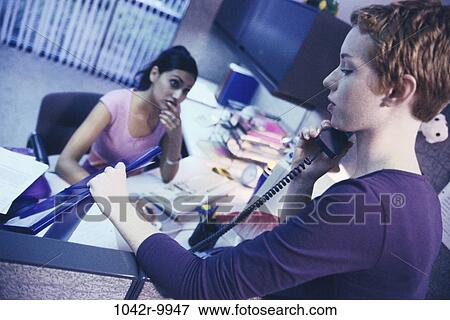 Stock Photo - women, desk, telephone, talking, phone, business, using. Fotosearch