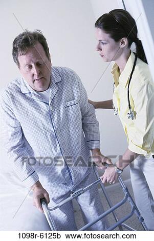 Stock Image - bed, patient, nurse, helping, bedroom, indoors, help. Fotosearch