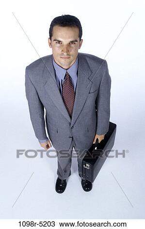 Stock Image - briefcase, Hispanic, business, businessman, indoors, young adult. Fotosearch