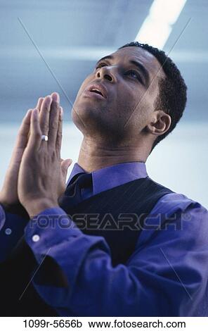 Stock Image - business, pray, businessman, praying, indoors, help. Fotosearch