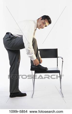 chair, Hispanic, business, businessman, indoors, tying View Large Photo Image Picture - chair, Hispanic, business, businessman, indoors, tying. Fotosearch
