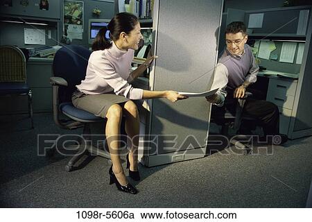 Stock Image - coworkers, paperwork, papers, business, Middle-aged, handing, giving. Fotosearch