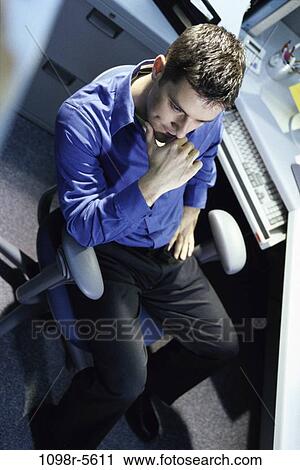 Stock Image - desk, business, contemplation, serious, contemplating, thinking. Fotosearch