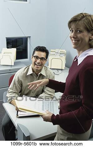 Stock Image - desk, business, Middle-aged, joyous, indoors, Caucasian, businesspeople. Fotosearch