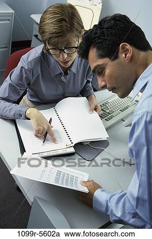 Stock Image - desk, business, Middle-aged, teamwork, indoors, Caucasian, businesspeople. Fotosearch