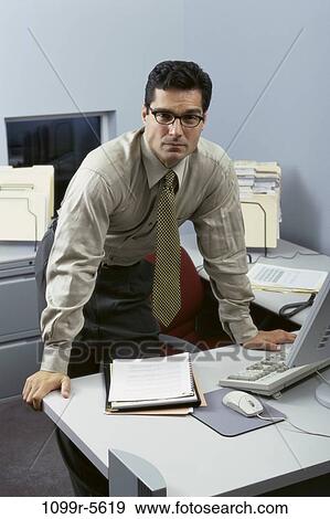 desk, eyeglasses, Hispanic, business, serious, businessman View Large Photo Image Stock Photo - desk, eyeglasses, Hispanic, business, serious, businessman. Fotosearch