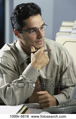 desk, eyeglasses, Hispanic, business, serious, contemplating View Large Photo Image Stock Photograph - desk, eyeglasses, Hispanic, business, serious, contemplating. Fotosearch