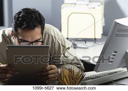 desk, eyeglasses, Hispanic, computer, reading, occupied View Large Photo Image Stock Photo - desk, eyeglasses, Hispanic, computer, reading, occupied. Fotosearch