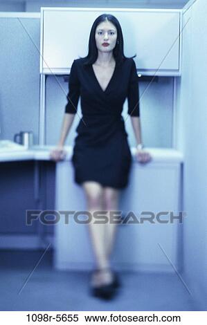 Stock Photography - desk, woman, Hispanic, business, indoors, businesswoman, young adult. Fotosearch