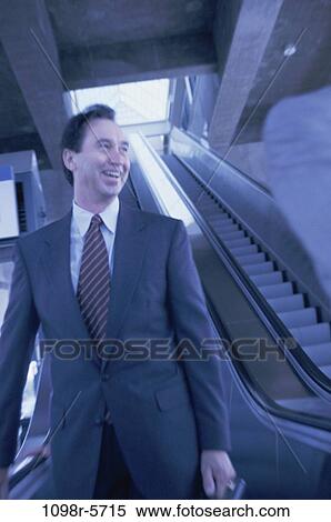 escalator, smiling, business, Middle-aged, smile, brunette View Large Photo Image Stock Photography - escalator, smiling, business, Middle-aged, smile, brunette. Fotosearch