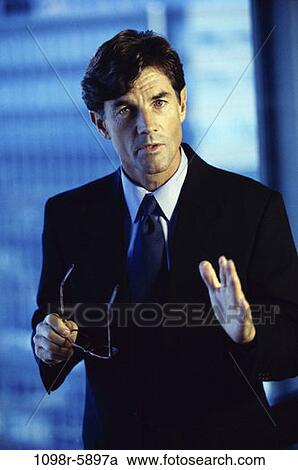 Stock Image - eyeglasses, business, Middle-aged, businessman, indoors, executive. Fotosearch