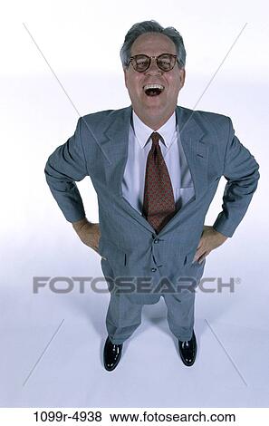 Stock Photo - eyeglasses, business, Middle-aged, humor, businessman, indoors. Fotosearch