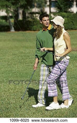 Field, people, golf, couple, outdoors, Middle-aged, pair View Large Photo Image Stock Photography - Field, people, golf, couple, outdoors, Middle-aged, pair. Fotosearch