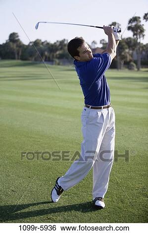 Stock Photograph - Field, playing, golf, outdoors, Middle-aged, play. Fotosearch