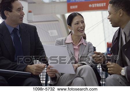 Stock Image - group, multiethnic, talking, conversation, sitting, business. Fotosearch