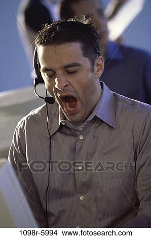 Picture - headset, business, tired, bored, casual, businessman. Fotosearch