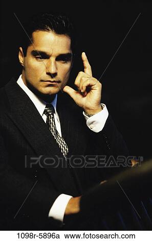 Stock Image - Hispanic, business, Middle-aged, serious, contemplating, businessman. Fotosearch
