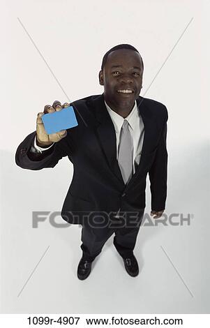 Stock Photo - holding, business, card, businessman, hold, credit card, indoors. Fotosearch