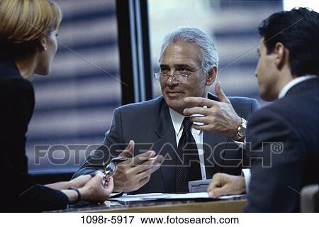 Stock Photo - meeting, formal, Middle-aged, executives, Caucasian, businesspeople, Businesspeople conferring. Fotosearch