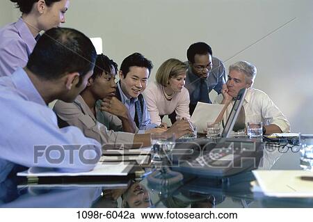 Stock Image - meeting, multiethnic, laptop, business, Middle-aged, teamwork, indoors. Fotosearch