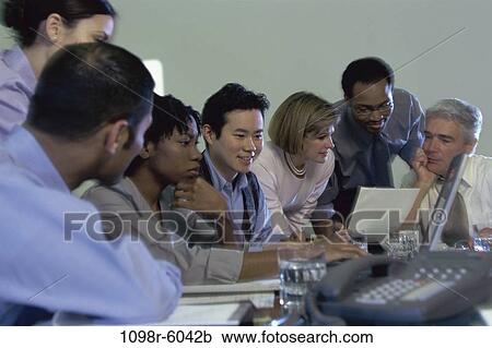 Stock Image - meeting, multiethnic, laptop, business, Middle-aged, teamwork, indoors. Fotosearch