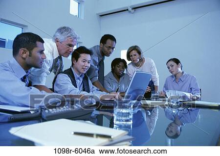 Stock Image - meeting, multiethnic, laptop, business, Middle-aged, indoors, casual dress. Fotosearch