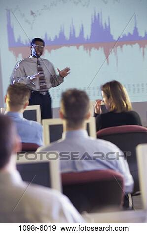 Stock Photo - meeting, multiethnic, presentation, business, Middle-aged, computers, education. Fotosearch
