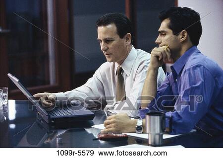 Stock Photo - men, desk, computer, laptop, business, Middle-aged, using. Fotosearch
