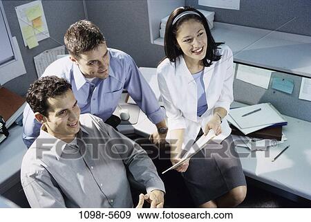 Stock Photo - multiethnic, desk, business, indoors, businesspeople, young adult, Businesspeople casual. Fotosearch
