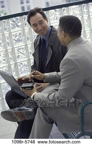 Stock Photo - multiethnic, men, computer, laptop, business, outdoors, Middle-aged. Fotosearch
