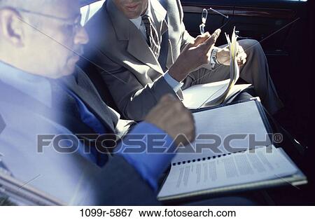 multiethnic, men, talking, papers, reading, business, businessmen View Large Photo Image Stock Photo - multiethnic, men, talking, papers, reading, business, businessmen. Fotosearch