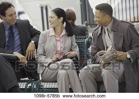 Stock Image - multiethnic, newspaper, business, outdoors, Middle-aged, travel, businesspeople. Fotosearch