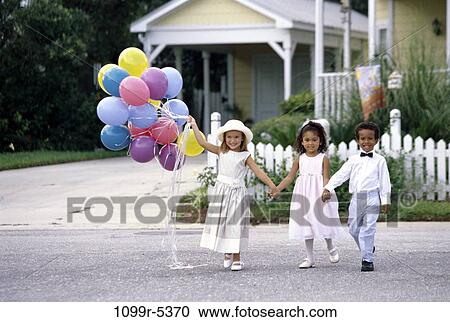 Stock Image - multiethnic, people, party, formal, walking, suit, balloons. Fotosearch