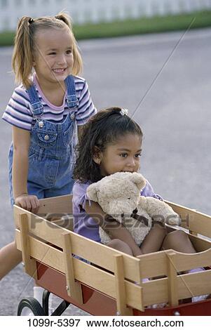 multiethnic, people, riding, outdoors, children, pushing, girls View Large Photo Image Stock Photo - multiethnic, people, riding, outdoors, children, pushing, girls. Fotosearch
