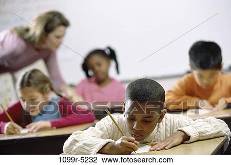 Stock Image - multiethnic, people, teacher, school, classroom, studying, writing. Fotosearch