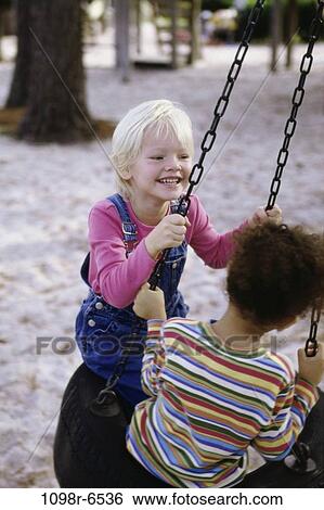 multiethnic, playing, swinging, swing, playground, stripes, outdoors View Large Photo Image Stock Photograph - multiethnic, playing, swinging, swing, playground, stripes, outdoors. Fotosearch