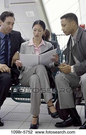 multiethnic, sitting, reading, business, outdoors, team View Large Photo Image Stock Image - multiethnic, sitting, reading, business, outdoors, team. Fotosearch