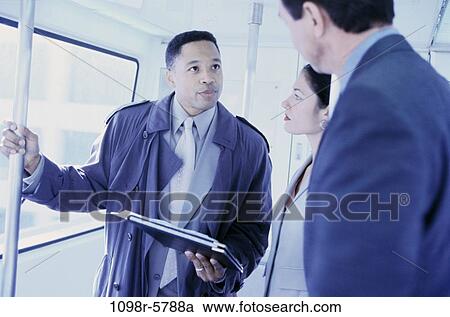 Stock Image - multiethnic, talking, train, business, Middle-aged, travel, talk. Fotosearch
