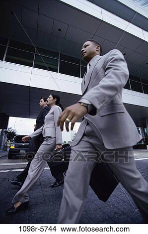 multiethnic, walking, business, outdoors, Middle-aged, carrying View Large Photo Image Picture - multiethnic, walking, business, outdoors, Middle-aged, carrying. Fotosearch