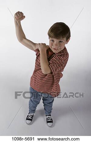 Stock Image - people, arm, boy, strength, child, jeans, T-shirt. Fotosearch