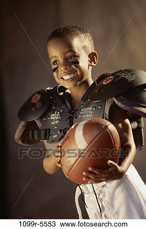 people, ball, football, boy, indoors, player, pads View Large Photo Image Stock Image - people, ball, football, boy, indoors, player, pads. Fotosearch