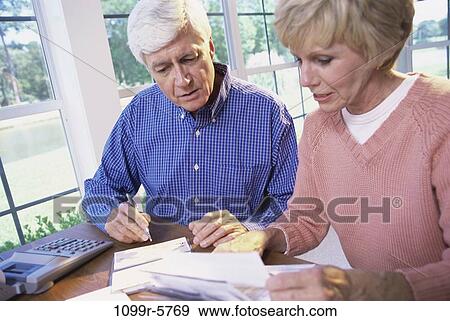 people, calculator, couple, senior, writing, serious, finance View Large Photo Image Stock Photo - people, calculator, couple, senior, writing, serious, finance. Fotosearch