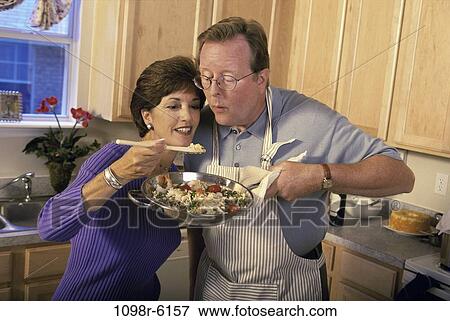 people, couple, cooking, equipment, Middle-aged, food, kitchen View Large Photo Image Stock Photo - people, couple, cooking, equipment, Middle-aged, food, kitchen. Fotosearch