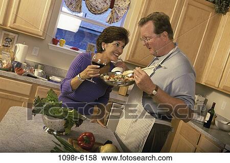 Stock Photo - people, couple, cooking, equipment, Middle-aged, food, kitchen. Fotosearch