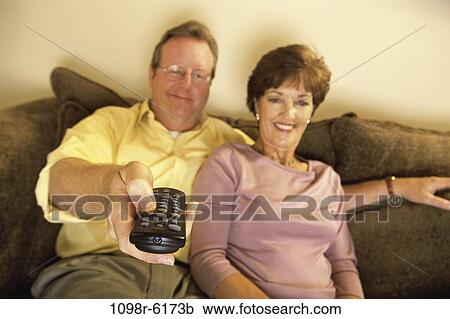 Stock Image - people, couple, eyeglasses, watch, Middle-aged, watching, television. Fotosearch